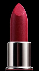 Bright red lipstick in silver tube against dark background highlighting beauty product details