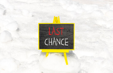 Last chance symbol. Concept word Last chance on beautiful black blackboard. Beautiful white snow background. White snow. Black blackboard. Business last chance concept. Copy space.