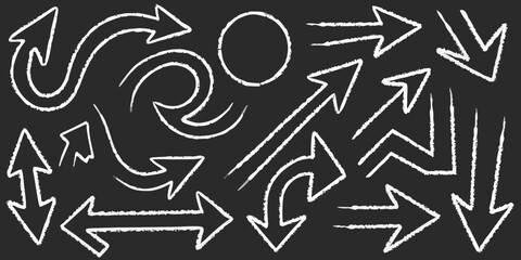 Collection of hand drawn white chalk arrows and a circle on a dark chalkboard background