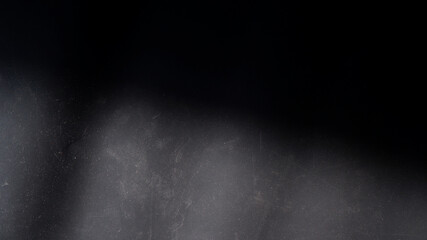 Black abstract background with strong shadow and sunlight reflects scratches and dust texture. Concept of grunge, dirty paper, shade, darkness, summer for wallpaper, design backdrop. Black surface.