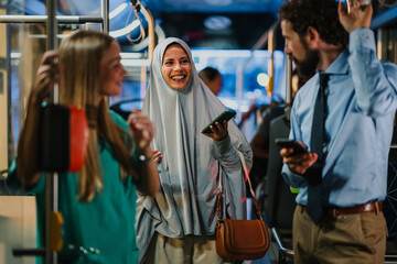 Diverse commuters using smartphones on a bus, connecting with technology during their journey