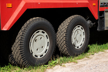 Obraz premium A Detailed Closeup View of Truck Tires Mounted on a Red Vehicle