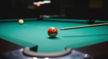Billiard ball on green table with cue stick ready to strike
