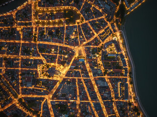 Drone aerial night view of illuminated city streets in Hoorn
