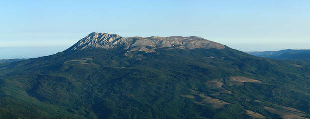 Mountain range covered with forests. Panoramic view of Chatyr-Dag mountain, upper part of plateau. The highest peaks of Crimean mountains.