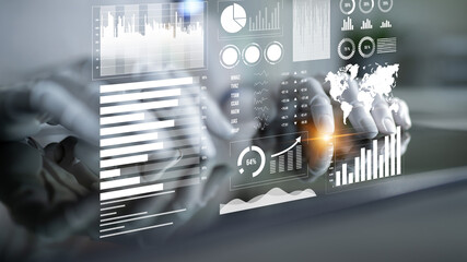 Hands engage with an advanced data visualization interface filled with informative charts, graphs, and statistics, showcasing modern business analysis tools. Impute