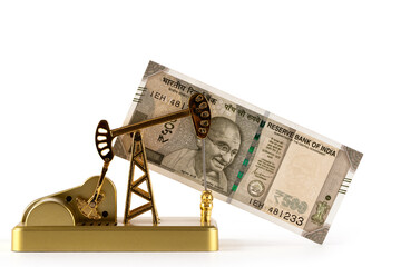 Miniature oil pump and 500 rupee note of the Republic of India on white background