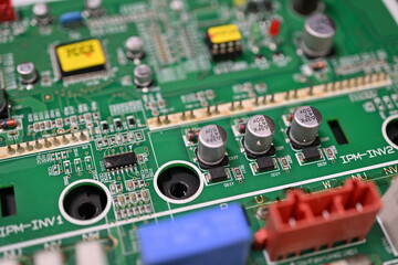 Close-up of rectifier diodes next to capacitors on a printed circuit board.
