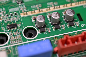 Close-up of rectifier diodes next to capacitors on a printed circuit board.
