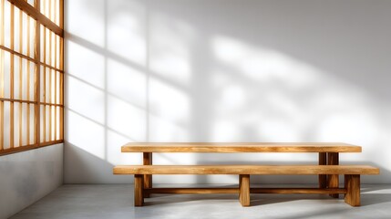 Fototapeta premium A simple wooden dining set casts elegant shadows on a white wall, lit by natural light filtering through a corner window.