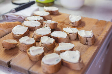The sliced ​​roll is spread with spread. Making canapes
