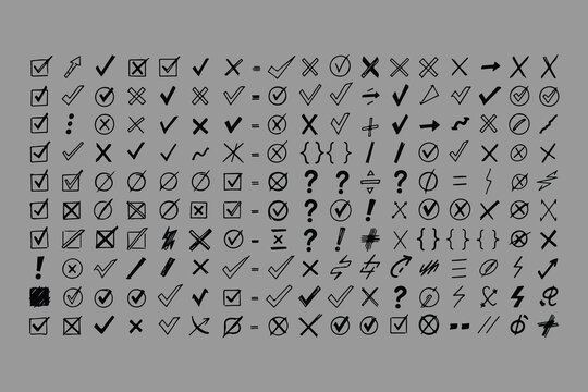 A comprehensive collection of hand drawn checkmarks crosses and various punctuation marks in black ink on a neutral gray background