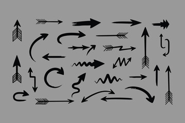 Collection of hand drawn arrows in various styles and directions on a solid gray background