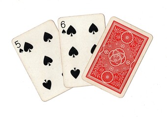 A hand of three vintage playing cards with two cards revealed on a white background.