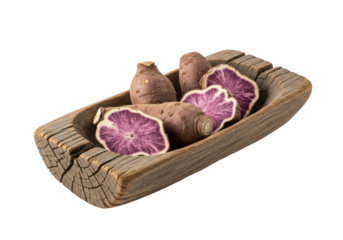 A shallow, hand-carved dark wood trough holding gnarly dehydrated purple yam wedges, against a transparent background with soft natural light, highlighting rustic authenticity and timelessness