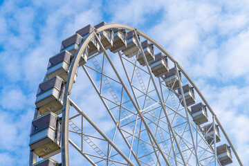 Ferris wheel with blue cloudy sky in the background in Hungary