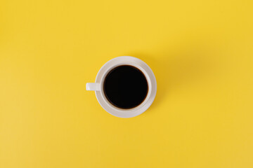 White Ceramic Coffee Cup on Yellow Background