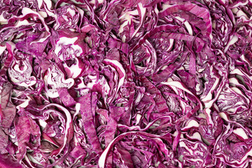 Chopped red cabbage background, close-up, with water droplets