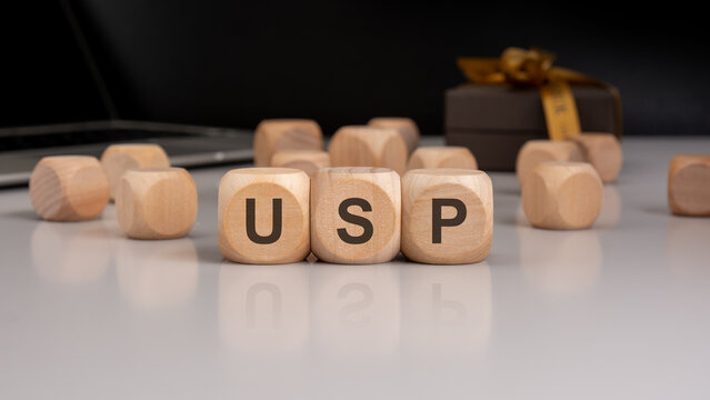 Naklejki Wooden cubes with letters USP symbolizing Unique Selling Proposition in business concept