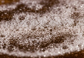 Macro shot of beer foam texture with bubbles, abstract background.