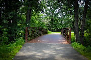 A beautiful pedestrian and bike bridge on a tree-lined trail in Rothschild, Wisconsin