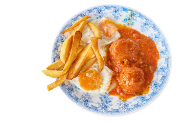 Meatballs in tomato sauce with fried eggs and chips on a plate