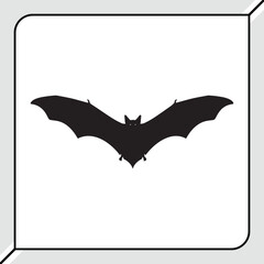 Fototapeta premium Silhouette of a black bat in flight with wings spread wide isolated on white background