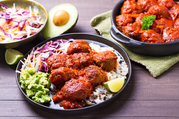 Beef meatballs in tomato sauce with rice, mashed avocado and coleslaw