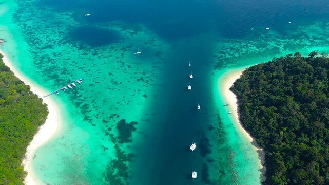 Beautiful tropical islands of Koh Rok in the south of Thailand. Green islands with cliffs, turquoise water near the shore and white beaches.