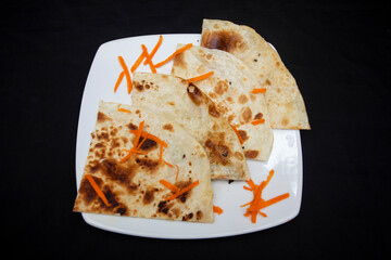 Indian butter pratha bread on a white plate Top view of Bangladeshi food