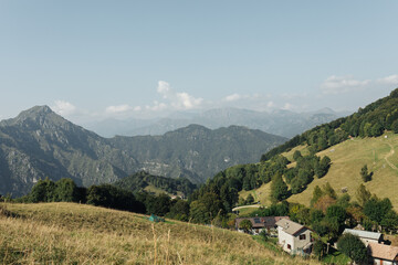 Fototapeta premium Scenic Mountain Landscape with Houses and Greenery