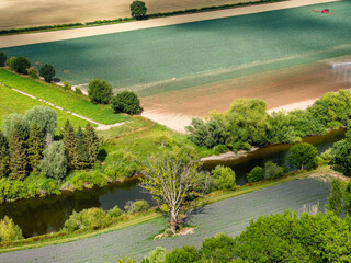 Aerial drone view of lush green farmland and the River Wye in summer, England