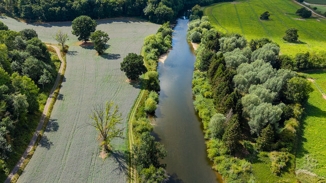 High angle view of the English countryside with a river, forest, and fields