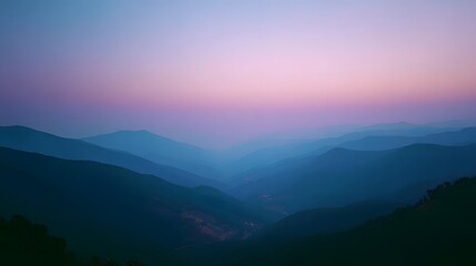 Fototapeta premium A tranquil vista of layered mountains bathed in a soft, pastel sunrise hue.