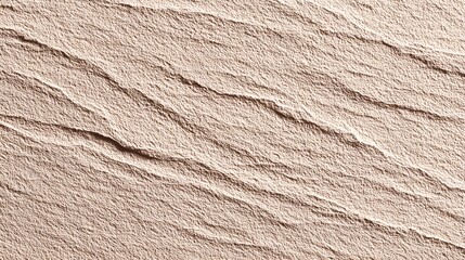 A close-up view of a textured light beige surface with flowing lines.