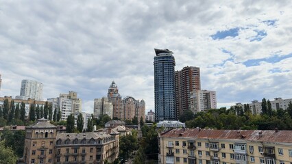 Fototapeta premium Architectural contrast in Kyiv — modern skyscrapers next to old historical buildings