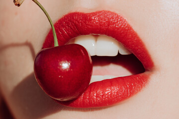 close up of woman lips with cherry