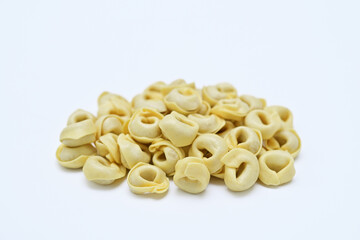 raw tortellini  ready to cook on white background close up