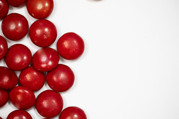 red covered coated milk chocolate candies on white background 