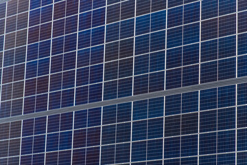 Solar panels installed on a building roof under sunlight, showcasing sustainable energy technology...