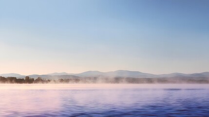 Obraz premium Misty morning landscape over a tranquil lake, with soft pastel hues and distant mountains.