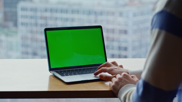Man hands tapping chromakey computer touchpad at cityscape workplace closeup