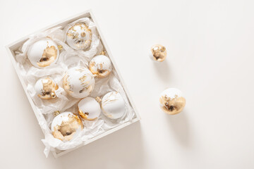 Beautiful Christmas white and golden balls in box for decorated Xmas tree on white background....