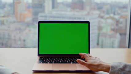 Hand pressing mockup laptop button closeup. Two teammates looking greenscreen