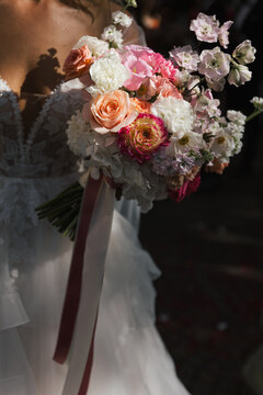 detail of bride holding a modern wedding bouquet of roses