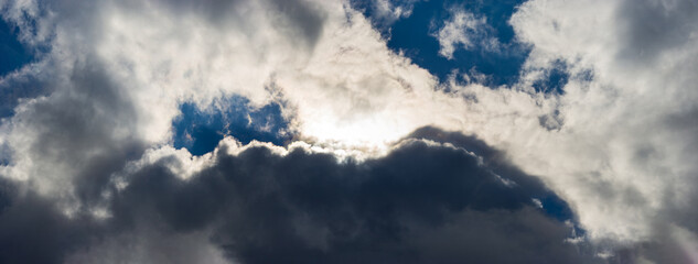 Dark cloud covers the sun's ray in the sky.