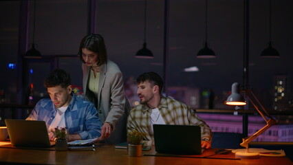 Late teammates looking solution working creative evening office. People deadline