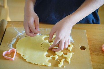 Child Making Heart Shaped Cookies with Dough and Cookie Cutter, Fun Homemade Baking Activity at Home