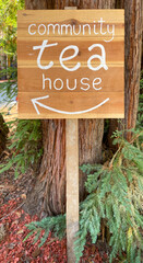 TEA HOUSE sign in forest setting