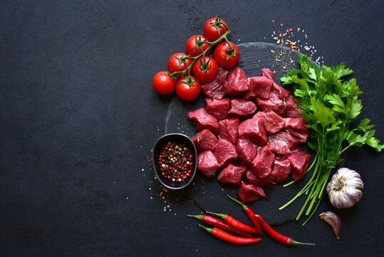 Raw organic meat cubes ( beef or lamb ). Top view with copy space.